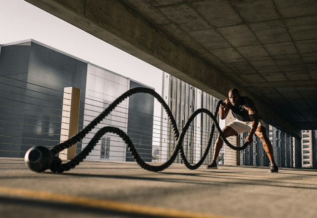 Athlete training with battle ropes