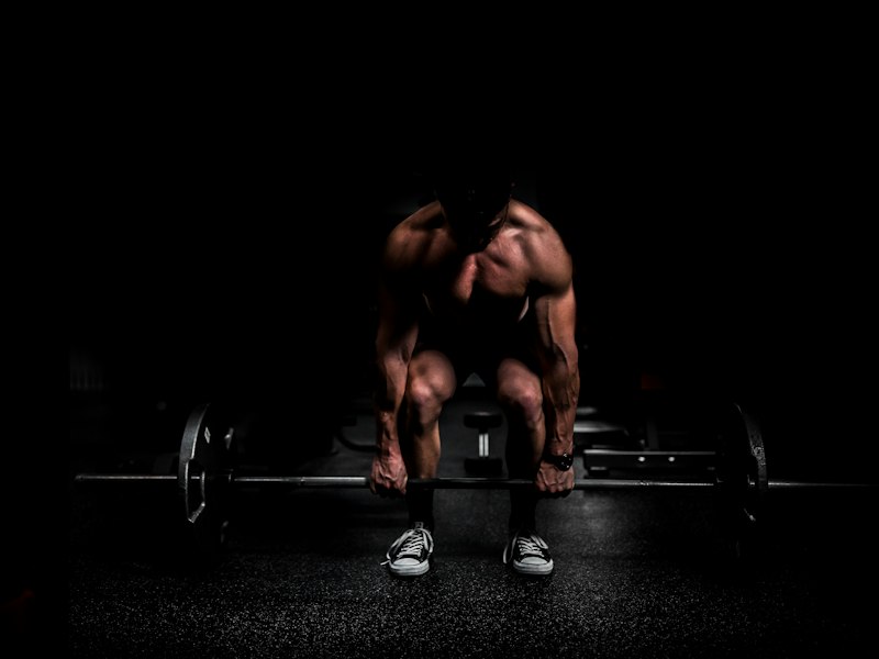 Athlete lifting a barbell off the floor
