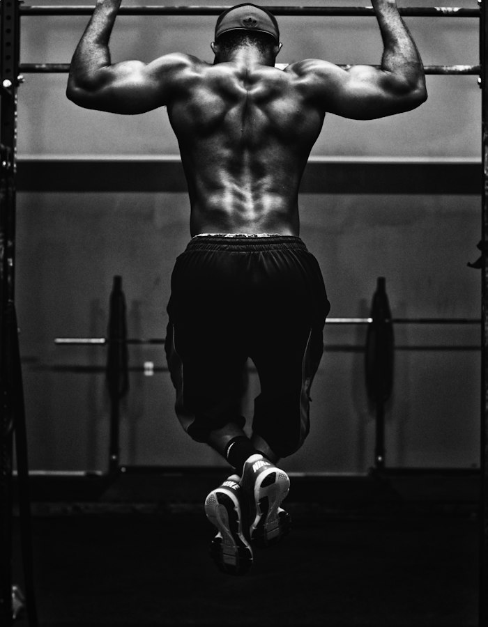 Athlete doing pull-ups on a rig